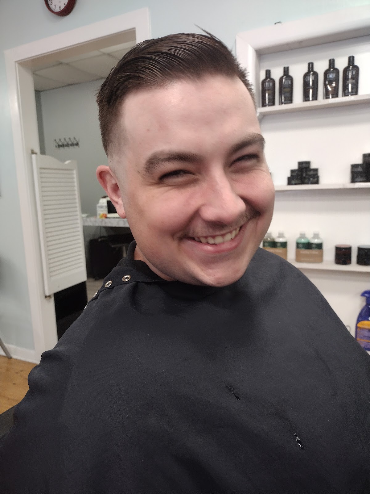 Happy client with a fresh cut at Palmetto Barbershop